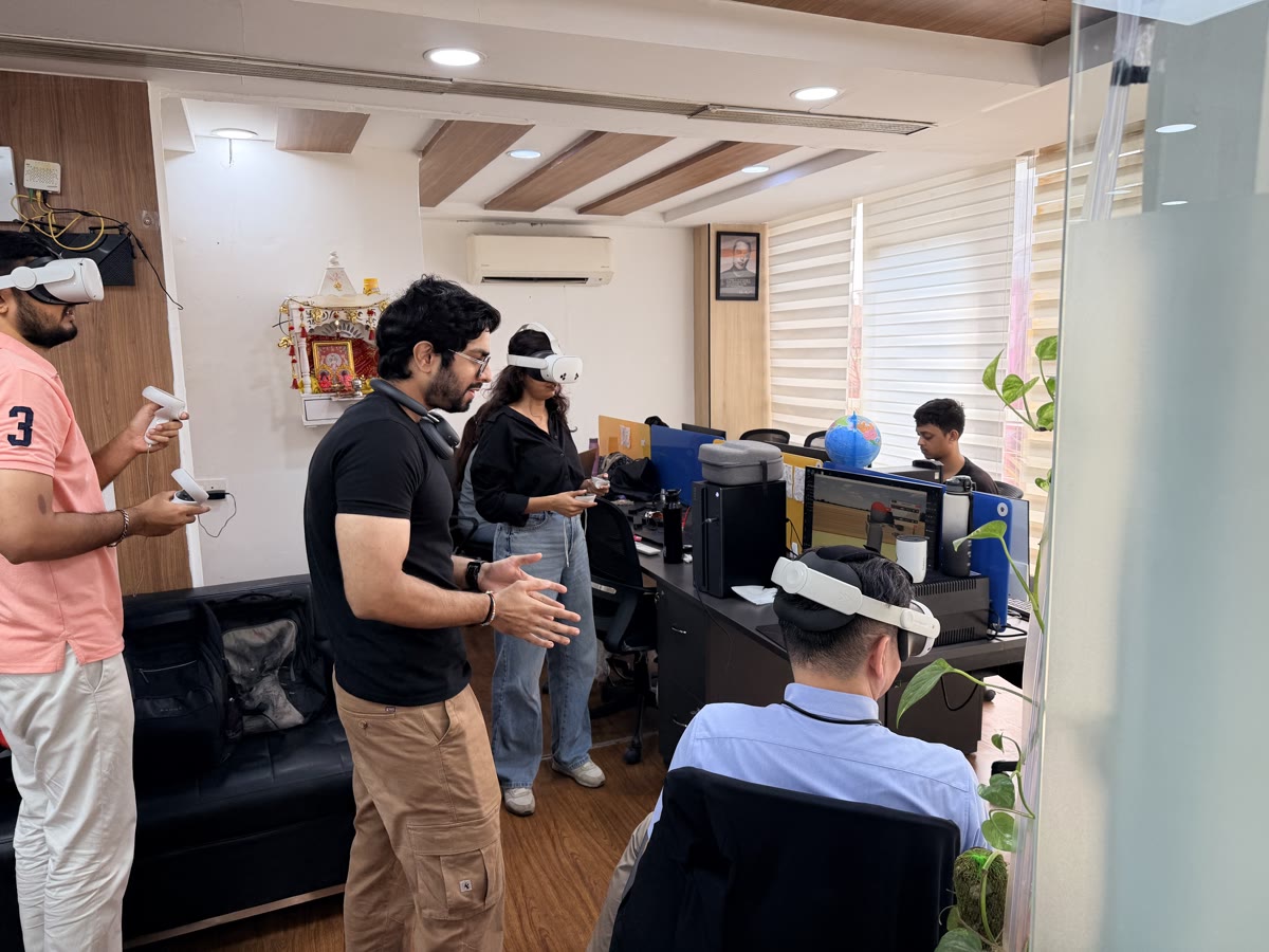 Four people in VR headsets during a multiplayer training session in the HapzXR office